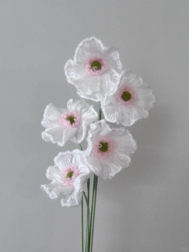 RivoArts handcrafted everlasting poppy bouquet. Five delicate lavender crochet flowers with white centers and fine thread texture.